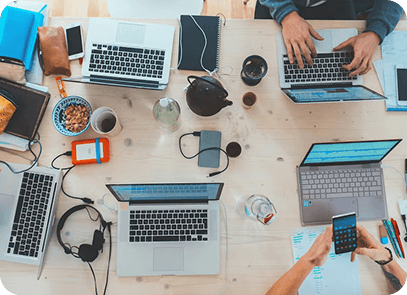 Overhead view of a team working with laptops